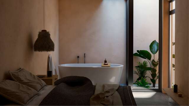 Moderna bañera de hidromasaje de diseño situada dentro de una espaciosa habitación de hotel.